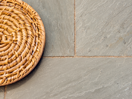 Dienblad en glas op platen van grijze zandsteen Kandla Grey van bovenaf