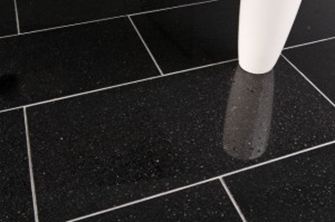 Een witte vaas op zwarte granieten tegels met lichtgekleurde voegen